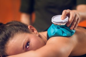 woman with cold treatment on shoulder