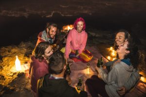 friends gathered round a campfire 