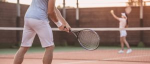 couple playing tennis competing with each other